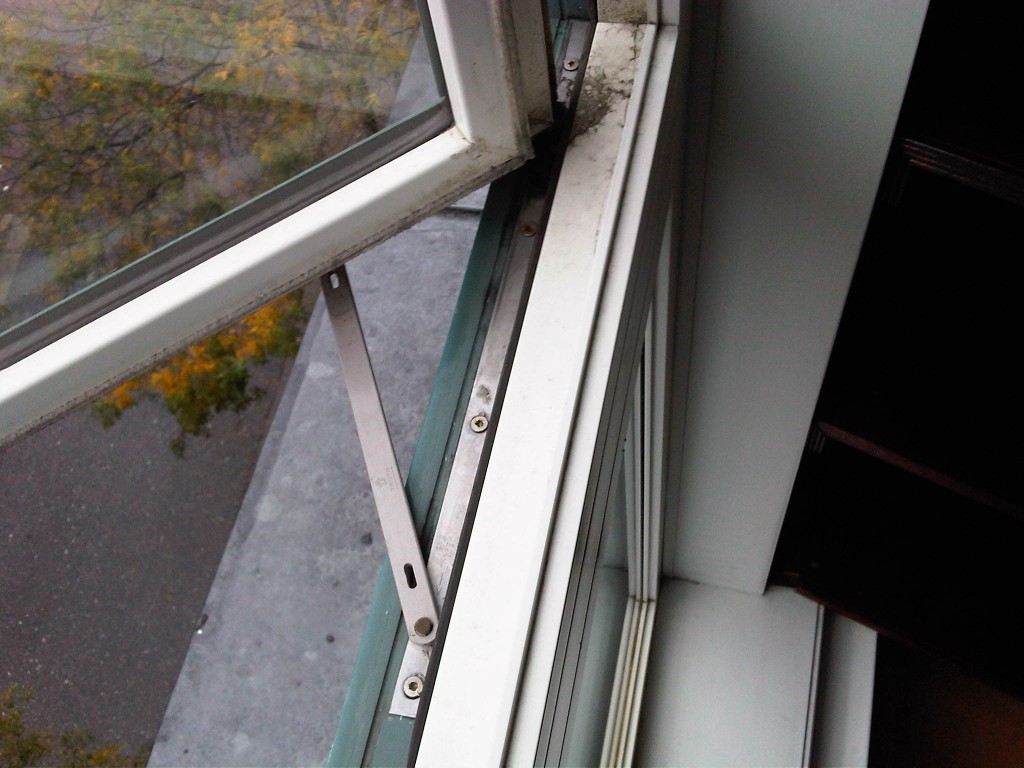 Window hardware replacement with new hinges installed to restore proper window function