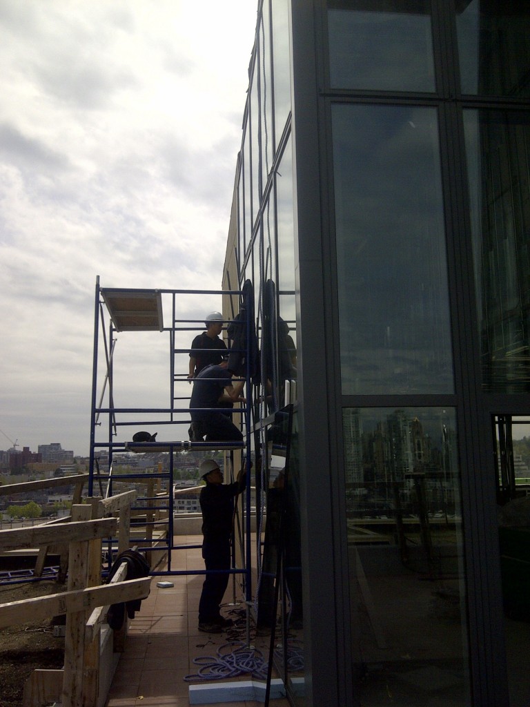 High rise apartment condo window replacement job. Apartment window replacement job requires 4 men to do the job. The large apartment window replacement glass was heavy double pane with cracks in it.
