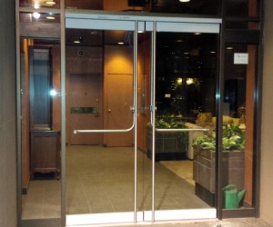 New elegant frameless glass doors system for hi rise apartment condo building in Downtown Vancouver. Door handles from inside are push panic for emergency exit access, while the electric strike locking system works seamlessly with the existing building's intercom system to allow for a swipe from card reader to allow access from the outside into the building.