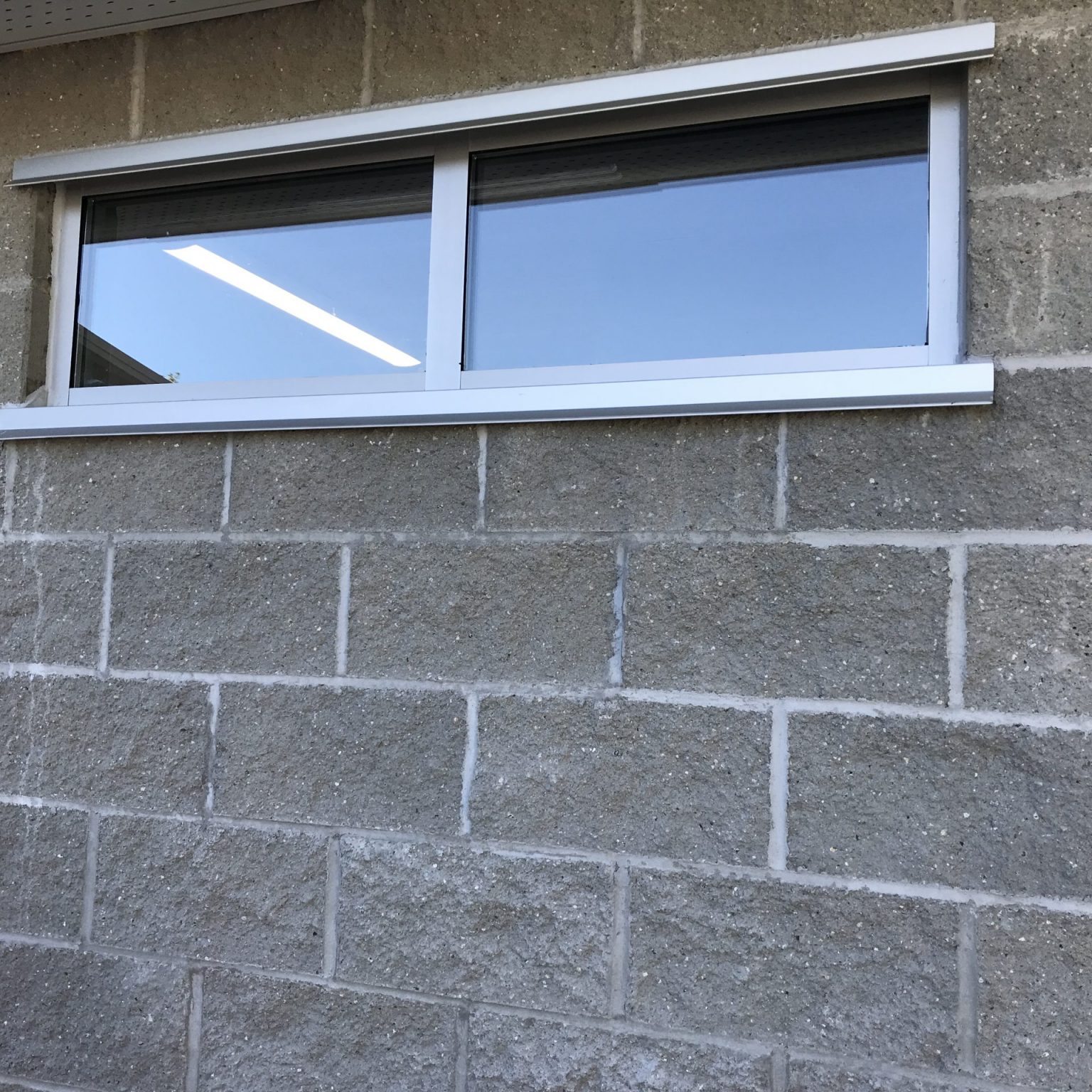 Installation of commercial strip window with opening pushout vent window that's all energy efficient and double glazed