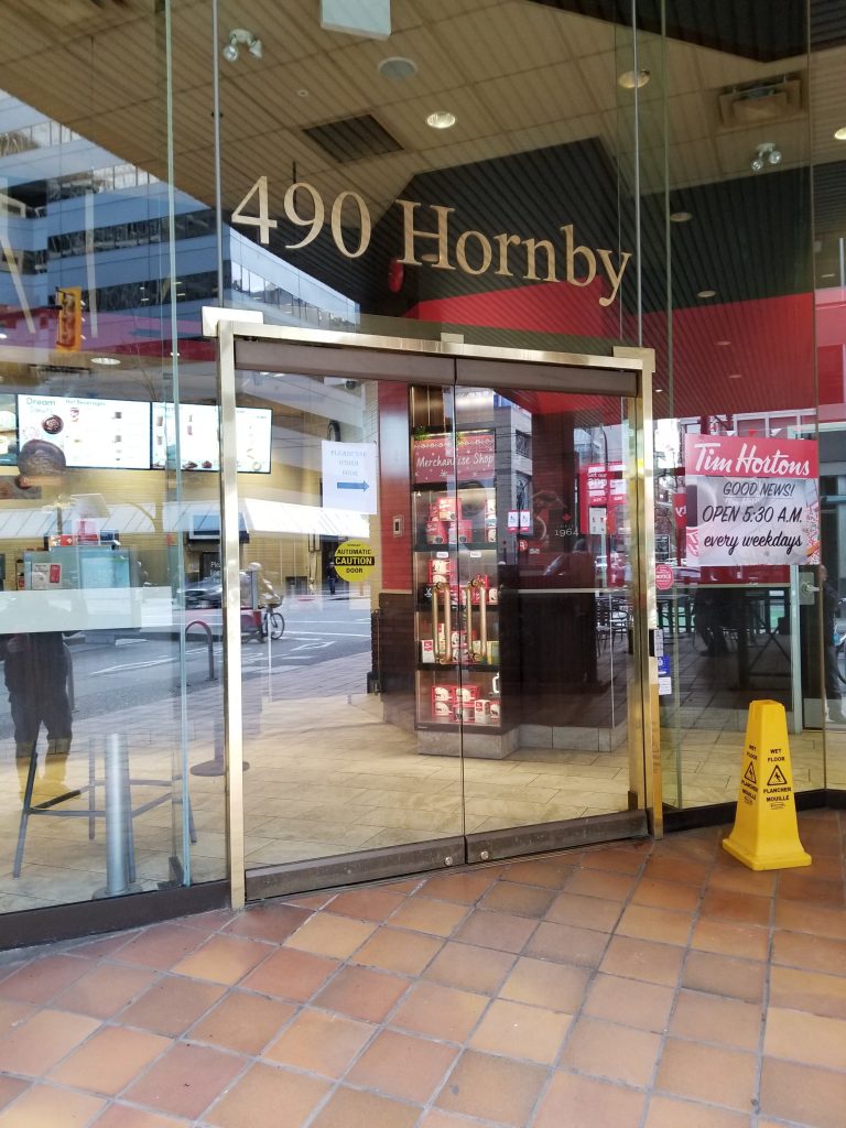 Frameless glass swing door with aluminum side windows